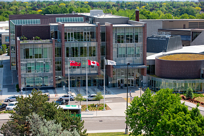 A student on a laptop looking for Centennial College services